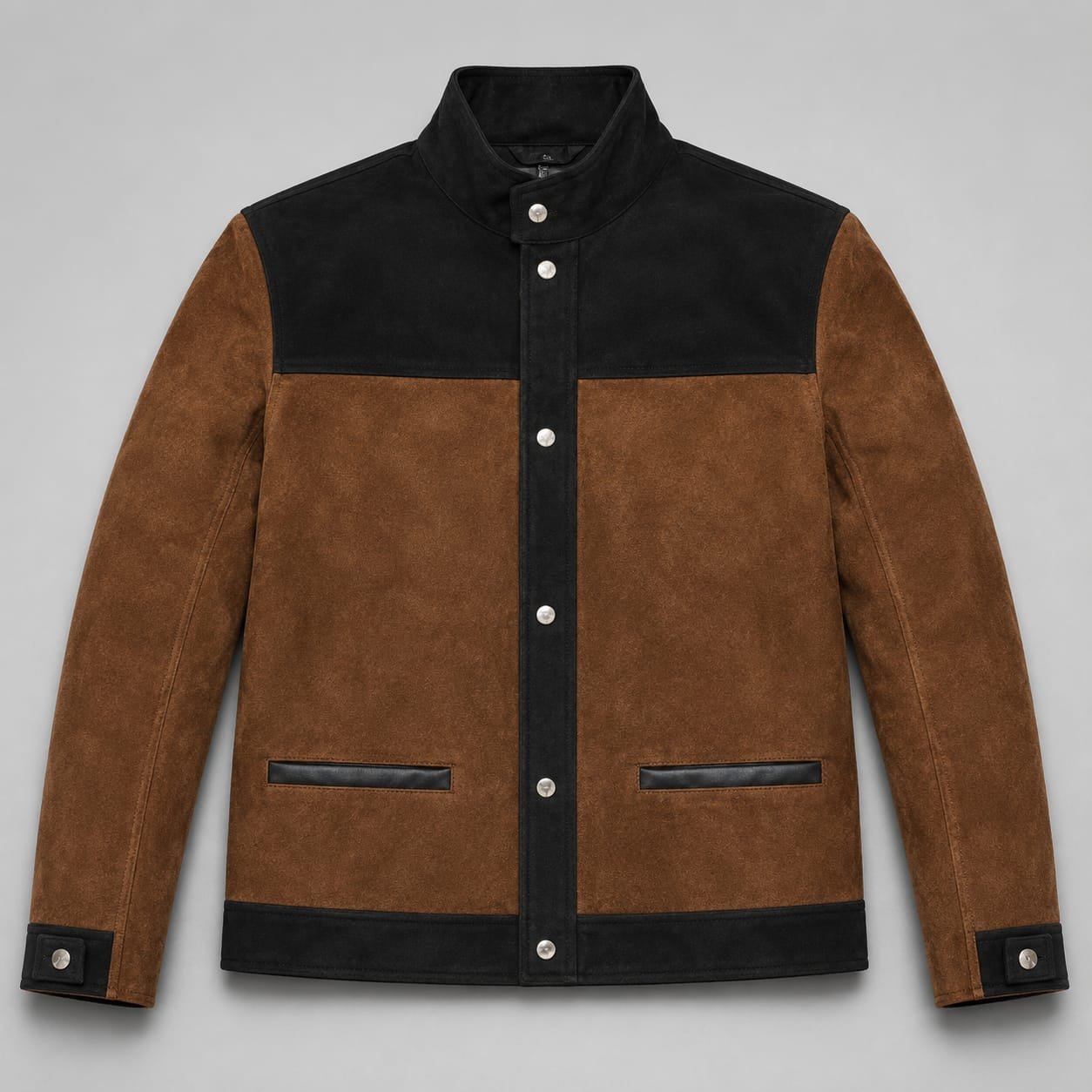 Alt Text: Men's brown and black suede leather jacket with a snap-button stand collar, front button closure, contrast yoke, long sleeves, and two welt pockets on a light gray background.